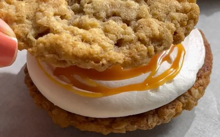 Cream Cheese Frosted Oatmeal Cookie Sandwich with Caramel Drizzle